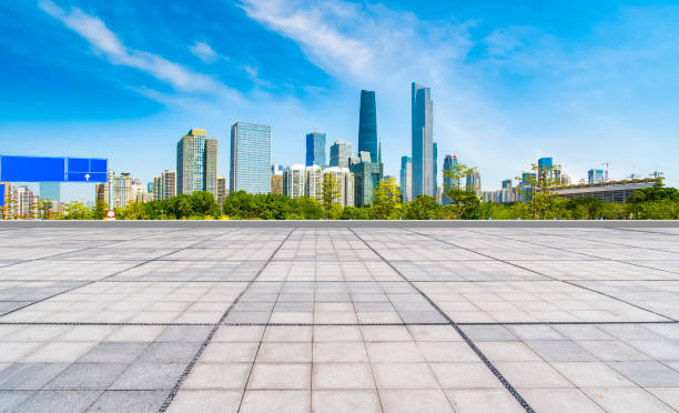 istock Empty square floor tiles and modern architecture in Guangzhou 1015864104