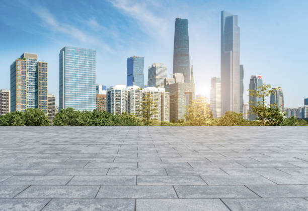 istock Empty square floor tiles and modern architecture in Guangzhou 1015864178