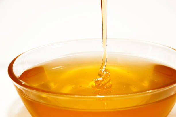 istock Honey pouring isolated on white background. 1015864924