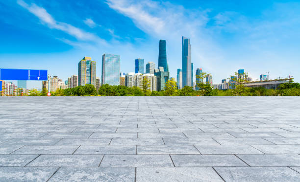 istock Empty square floor tiles and modern architecture in Guangzhou 1015867864