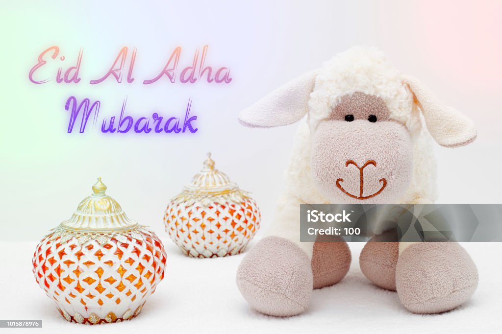 Greeting card on white background. Eid Al Adha sacrifice festival, Islamic Arabic candle and sheep. Eid al adha mubarak means happy festival of sacrifices Animal Stock Photo