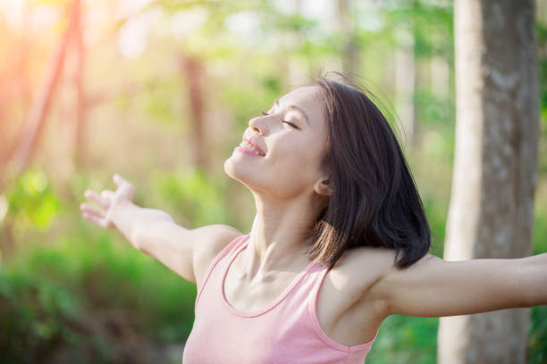 istock woman feel free in forest 1015879484