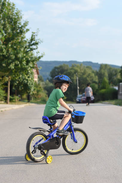istock Five years old boy rides a bicycle in the city 1015886940