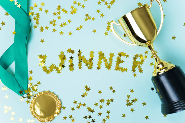 istock gold medal and cup on blue  background 1015887000