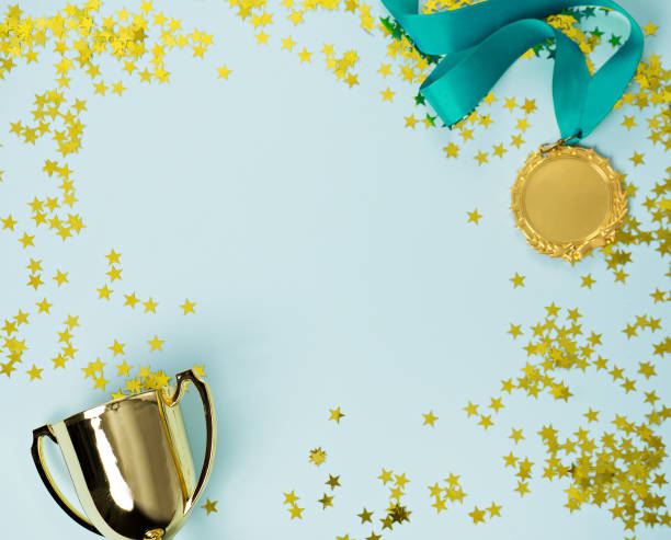 istock gold medal and cup on blue background 1015887026