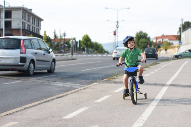 istock Five years old boy rides a bicycle in the city 1015887542