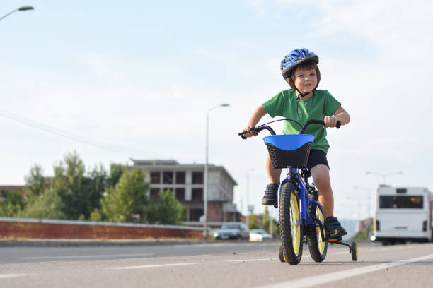 istock Five years old boy rides a bicycle in the city 1015887598