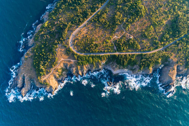 istock Cliffs, road and sea shore - gorgeous rural scene aerial view 1015887624