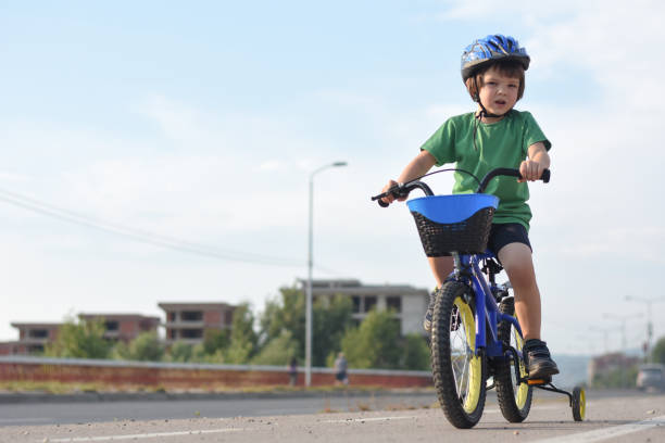 istock Five years old boy rides a bicycle in the city 1015888214