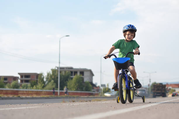 istock Five years old boy rides a bicycle in the city 1015890312