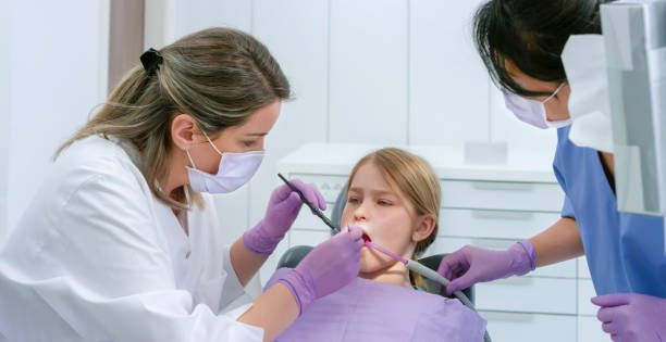 istock Female dentist checking patient's tooth 1015890364
