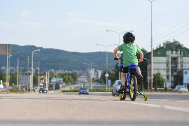 istock Five years old boy rides a bicycle in the city 1015891130