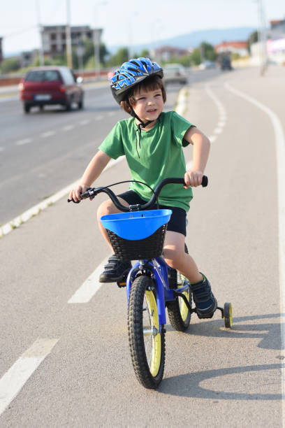 istock Five years old boy rides a bicycle in the city 1015894038