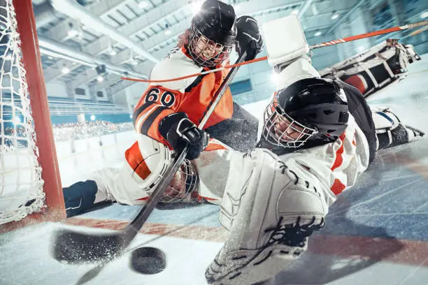 Photo of The ice hockey sport female players in action, motion, movement. Sport comptetition concpet, girls on training or game at arena