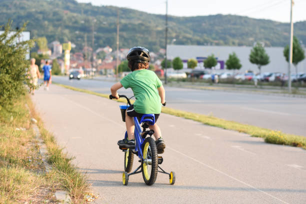 istock Five years old boy rides a bicycle in the city 1015898356