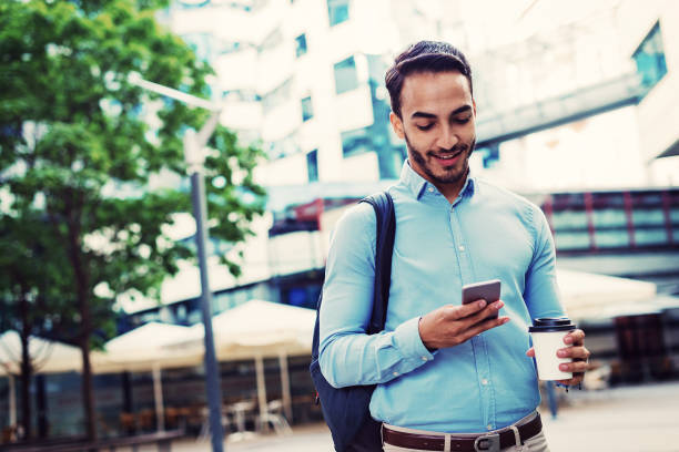 istock Latino man using mobile phone for business 1015903668
