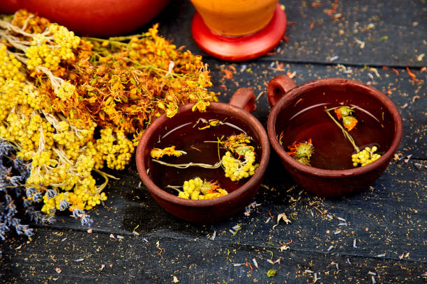 istock Healing herbs on wooden black table, herbal medicine 1015909486