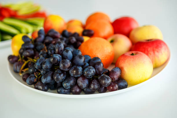 istock grapes and apples on a white plate 1015909632