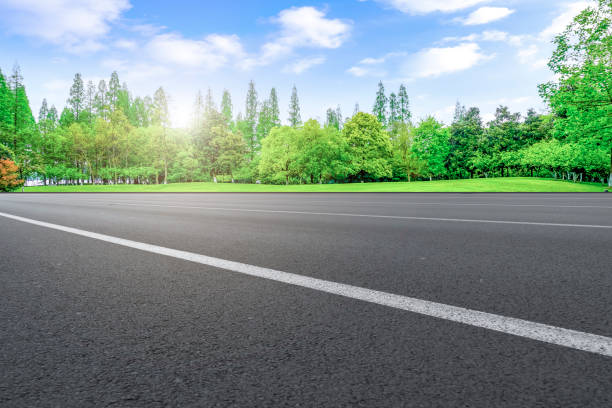 istock Empty highway asphalt road and beautiful sky landscape and forest 1015910528