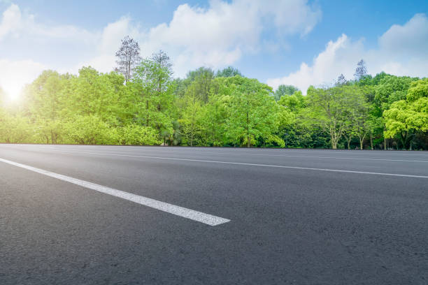 istock Empty highway asphalt road and beautiful sky landscape and forest 1015912892