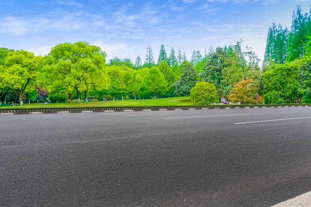 istock Empty highway asphalt road and beautiful sky landscape and forest 1015913780