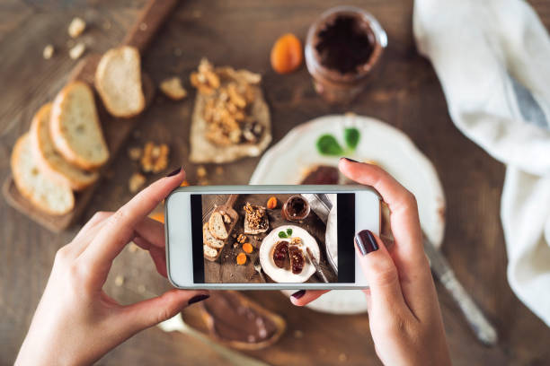 istock Woman taking a photo of breakfast table 1015914070