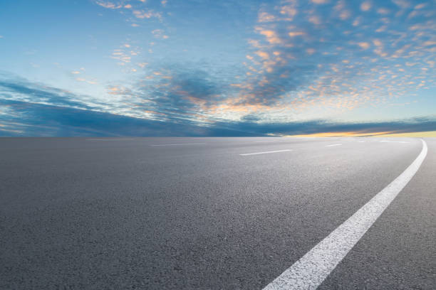 istock Empty highway asphalt road and beautiful sky landscape and forest 1015914218