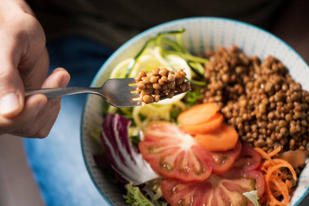 istock young man eating a buddha bowl 1015917258