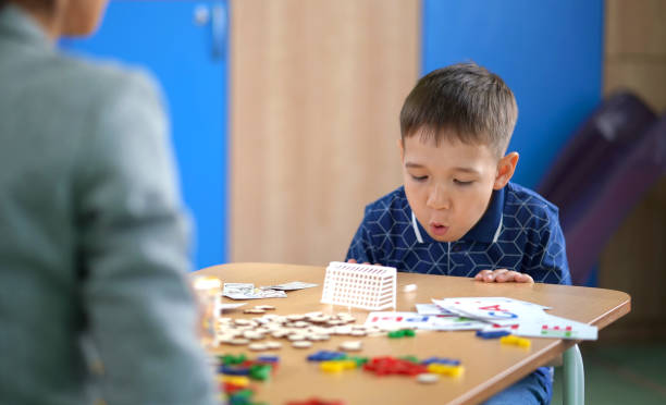 istock Boy Is Doing Spesial Breathing Exercise at Speech Therapy Lesson 1015922428