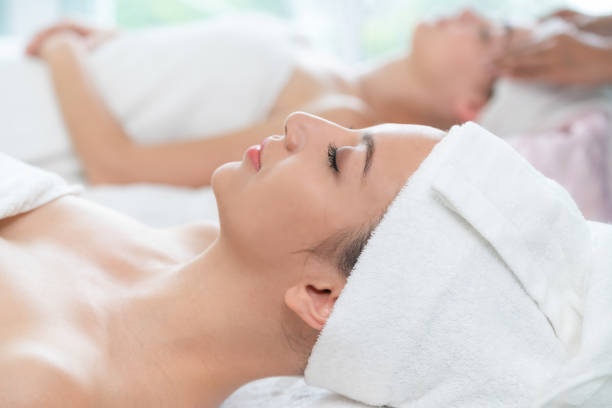 istock Relaxed young woman lying on spa bed for massage. 1015927162