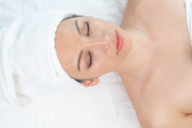 istock Relaxed young woman lying on spa bed for massage. 1015927346