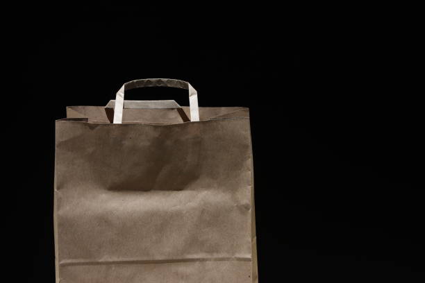 brown paper shopping bag  on a black background