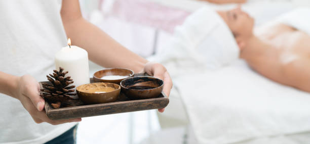 istock Massage therapist with hot spa treatment set. 1015927464