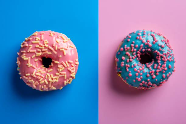 istock Colorful tasty glazed donuts on a colored background. 1015928620