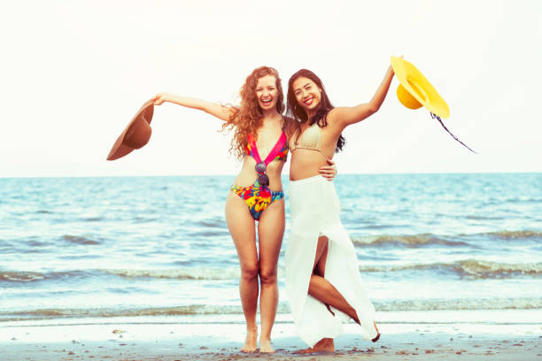 istock Happy women dance on sand beach in summer. 1015933788