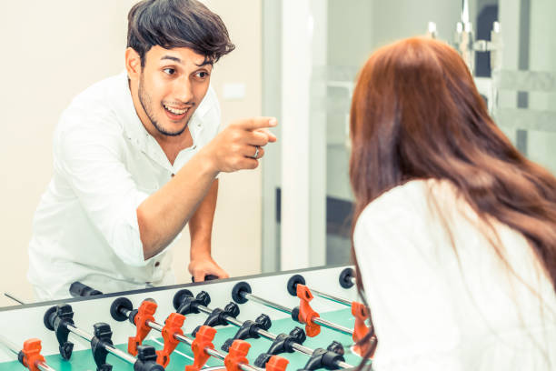 istock Happy couple playing foosball table. 1015934136