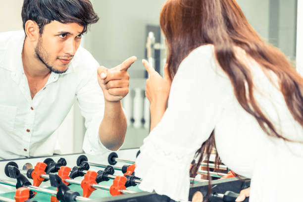 istock Happy couple playing foosball table. 1015934148