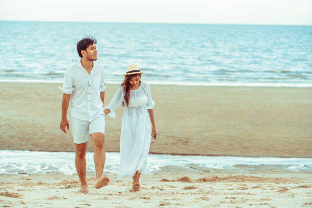 istock Happy young couple walk on the beach on honeymoon. 1015934594