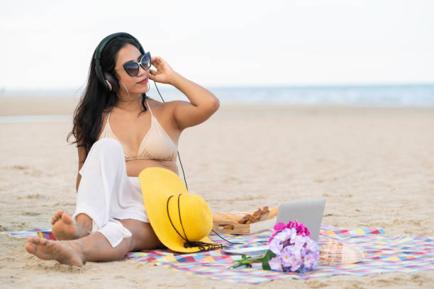 istock Plus size young woman sitting on the beach. 1015934720