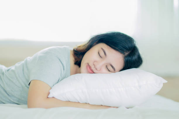istock Young asian girl sleeping on the white bed 1015937712