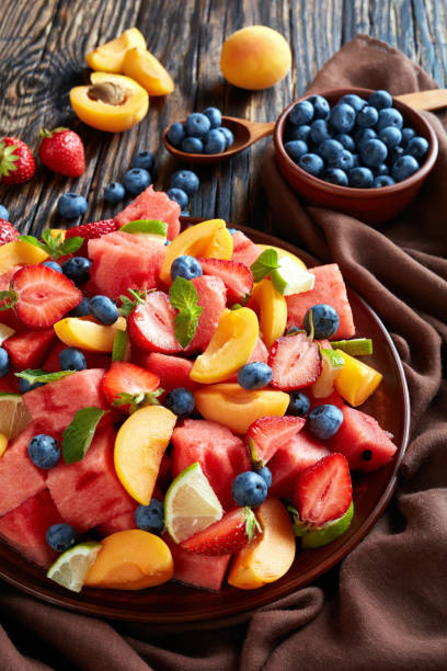 istock colorful fresh fruit salad, top view 1015937820