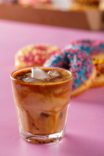 istock Ice coffee with donuts on a pink background. 1015938600