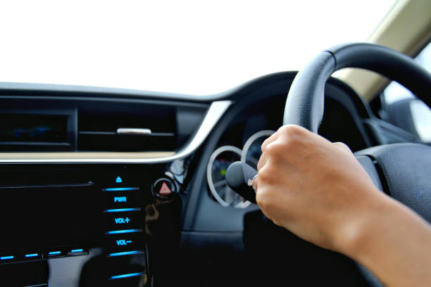 Hand of the woman hold the control wheel and drive the car stock photo