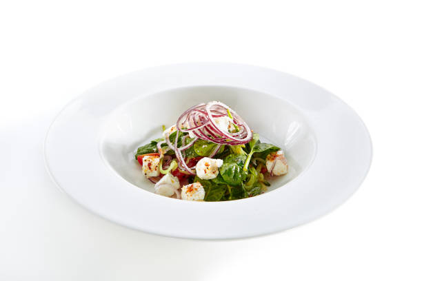 istock Salad with Goat Cheese, Spinach, Tomato and Onions Isolated 1015942132
