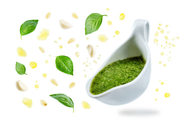 istock Pesto sauce with flying ingredients to prepare it 1015942346