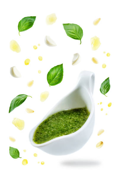 istock Pesto sauce with flying ingredients to prepare it 1015942348