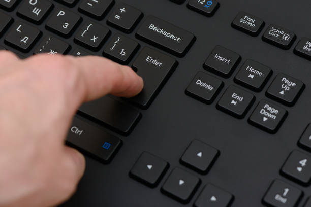 istock index finger presses the Enter key on the black keyboard 1015942722