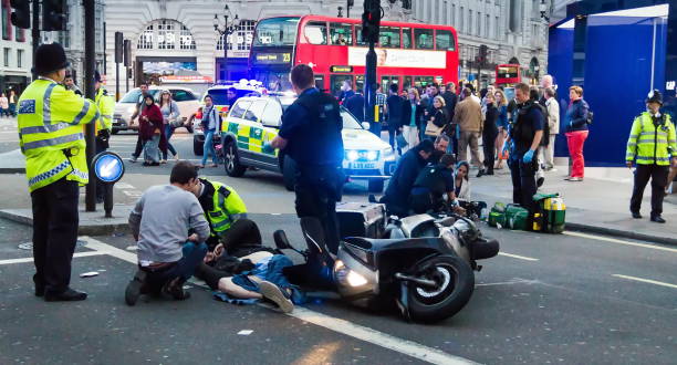 Paramedics provide first aid to victims in a motorcycle accident. London stock photo