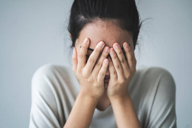 Young girl covering her face with her hands Young girl covering her face with her hands embarrassment stock pictures, royalty-free photos & images