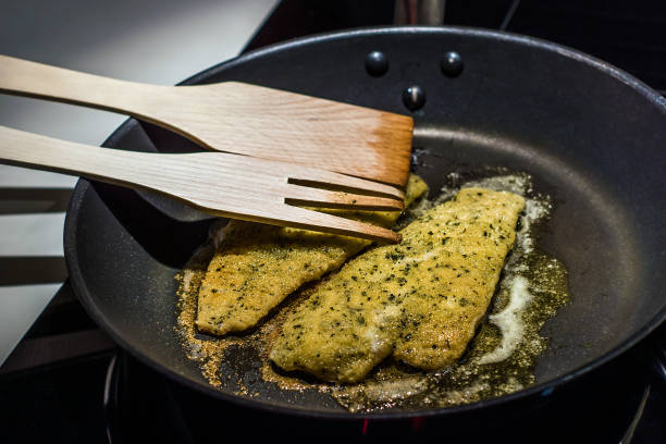 Plaice meuniere fillets being cooked in the pan